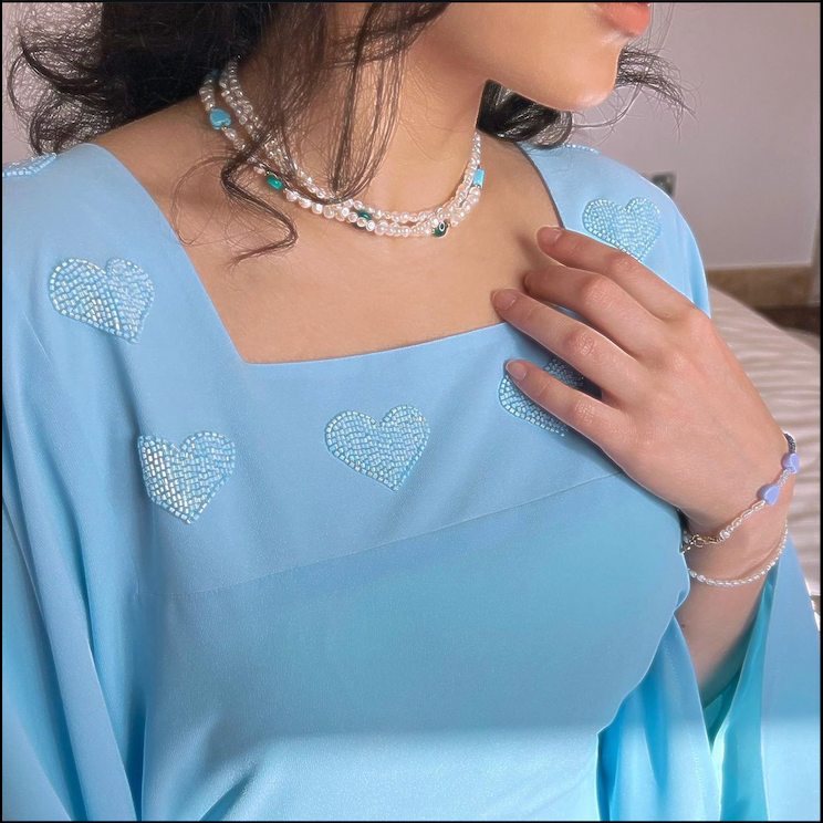 Styled with a coordinated outfit, this layered pearl choker adds a graceful, ethereal touch to any look.