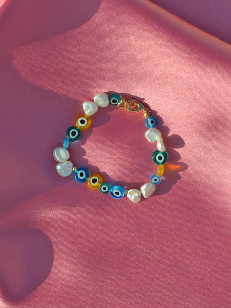 Bibi's Fairuz Eyes Bracelet: Mix of keshi freshwater pearls and glass evil eye beads in blue, green and yellow colour.