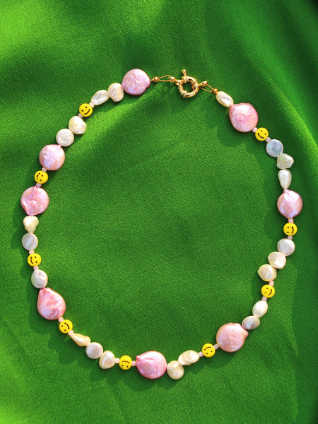 Mr. Happy in Love Necklace: Mix of small freshwater and keshi freshwater pearls with large pink circular pearls. Light pink acrylic beads and vintage looking smiley face beads.